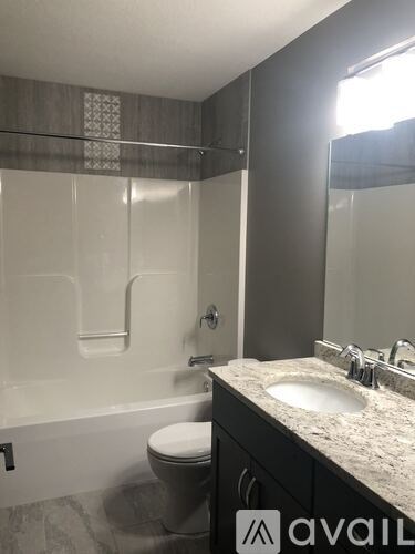 A bathroom with a toilet, sink, and shower.