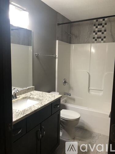 A bathroom with a toilet, sink, and bathtub.