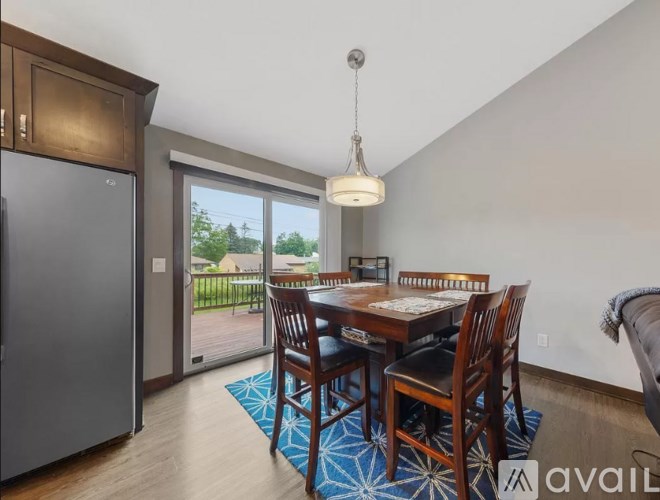 A kitchen with a dining table and chairs is available for rent.