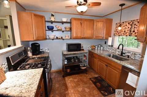 A kitchen with a black stove top oven and a black microwave.