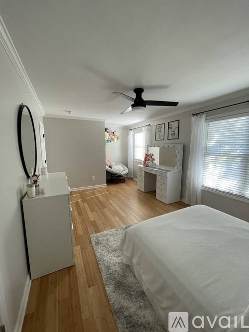 A bedroom with a bed, dresser, and mirror.