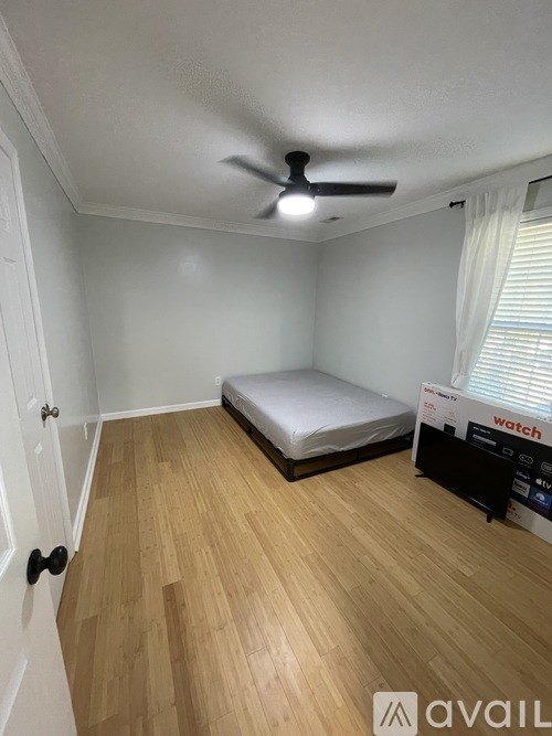 A room with a bed and a fan.