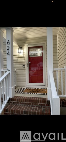 A red door with a number 6024 on the wall above it.