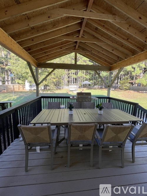 A wooden deck with a table and chairs.