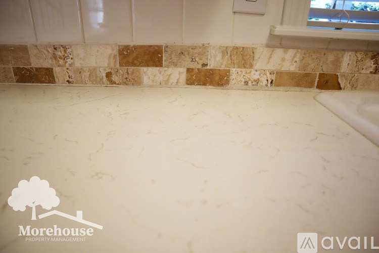 A tile floor with a logo for Morehouse Property Management.