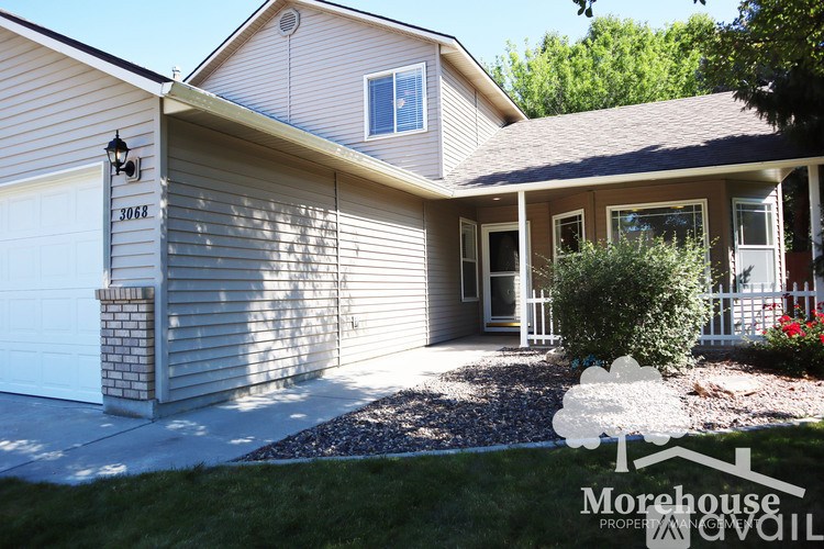 A house with a garage and Morehouse Property Available sign.
