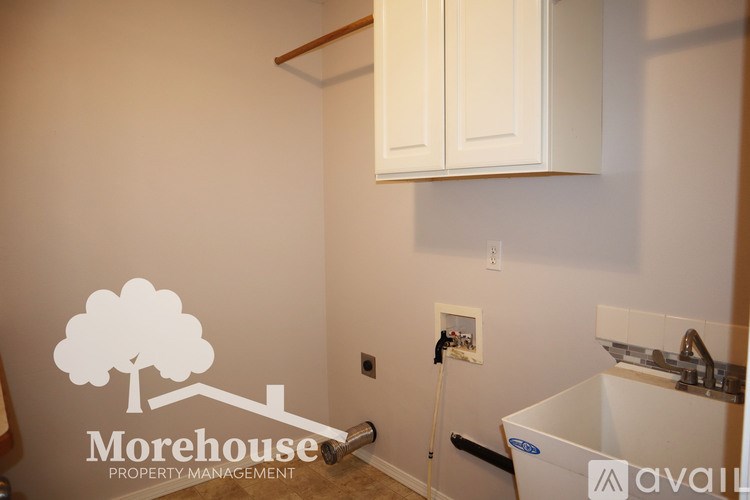 A Morehouse Property Management logo is on a wall above a sink.