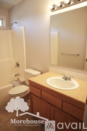 A white toilet sits next to a sink in a bathroom.