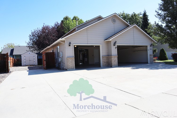 A house with a Morehouse Property Management logo on the ground.