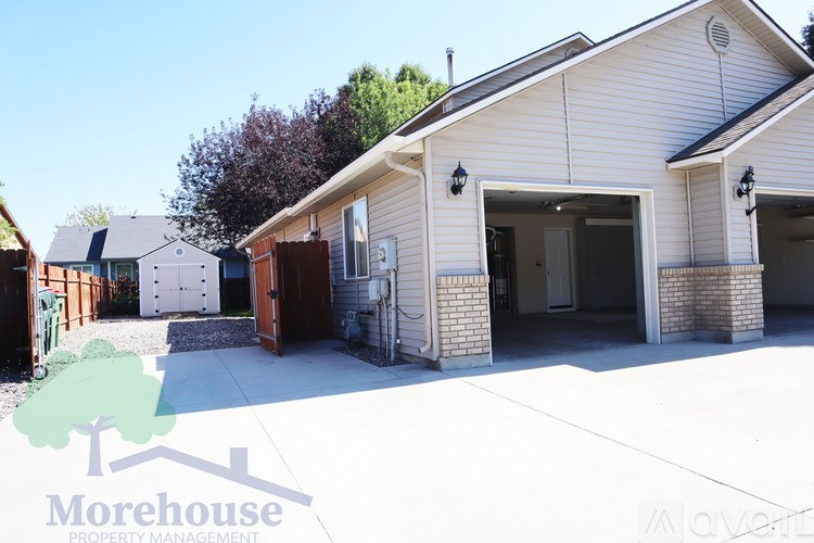 A white house with a Morehouse Property Management logo.