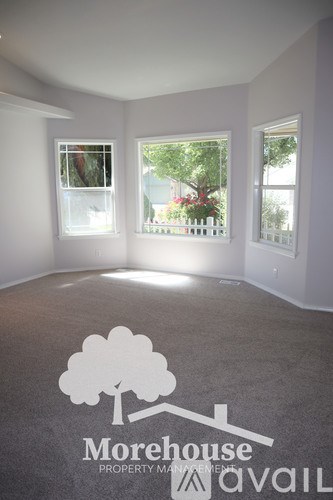 A room with a tree logo and Morehouse Property Management written on the floor.