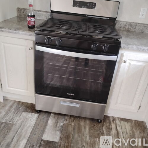 A stainless steel oven with a glass door is in a kitchen.