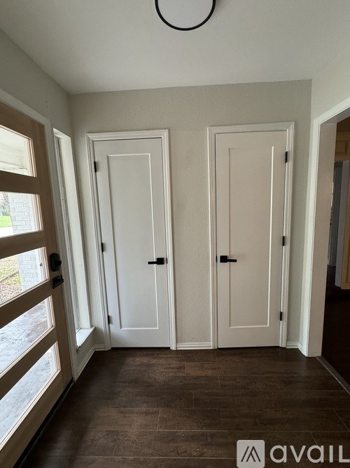 A room with two doors and a window.