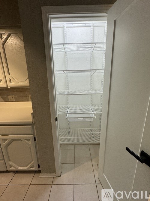 A white refrigerator with the door open in a kitchen.