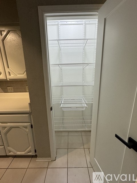 A white refrigerator with the door open in a kitchen.