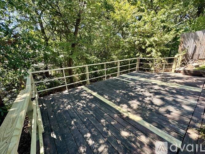 A wooden deck surrounded by trees.