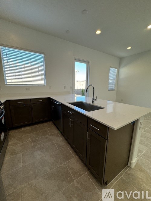 A kitchen with brown cabinets and a white countertop.