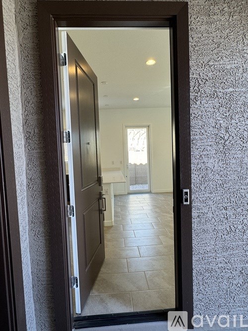 A room with a tiled floor and a wallpapered wall.