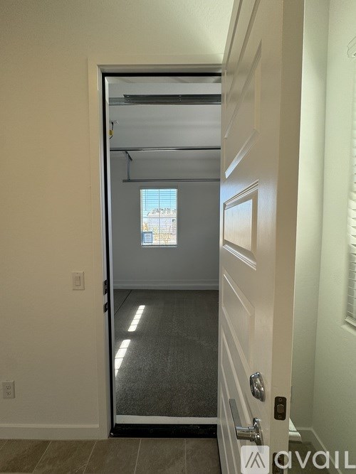 A white door with a glass window in the middle of a room.