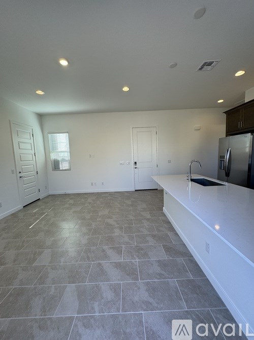 A kitchen with tile flooring and a countertop.