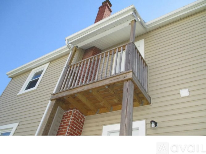 A house with a balcony and a chimney.