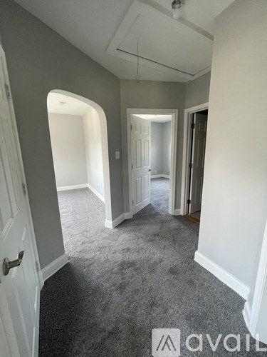 A room with carpeted floor and white walls.