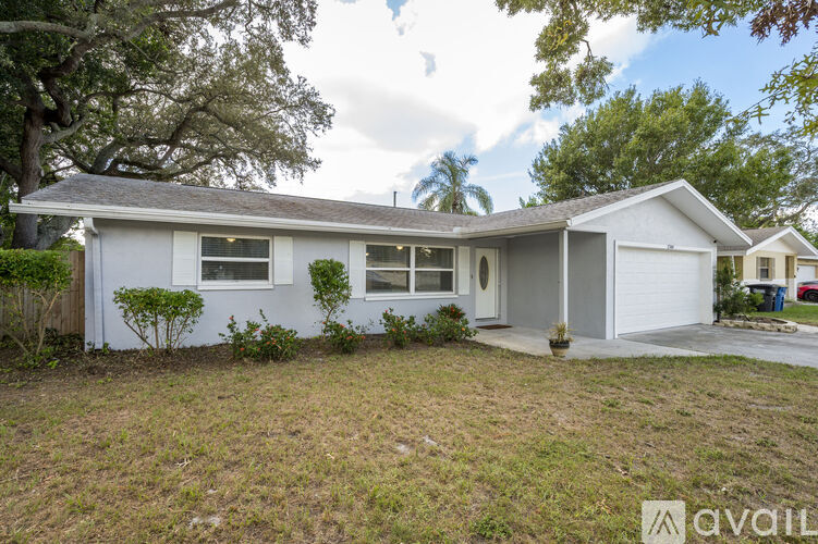 A house with a white exterior is for sale.