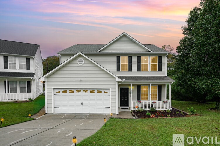 A house with a white garage door is for sale.