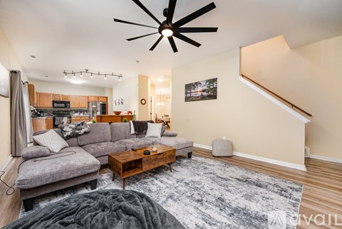 A living room with a grey couch and a wooden coffee table.