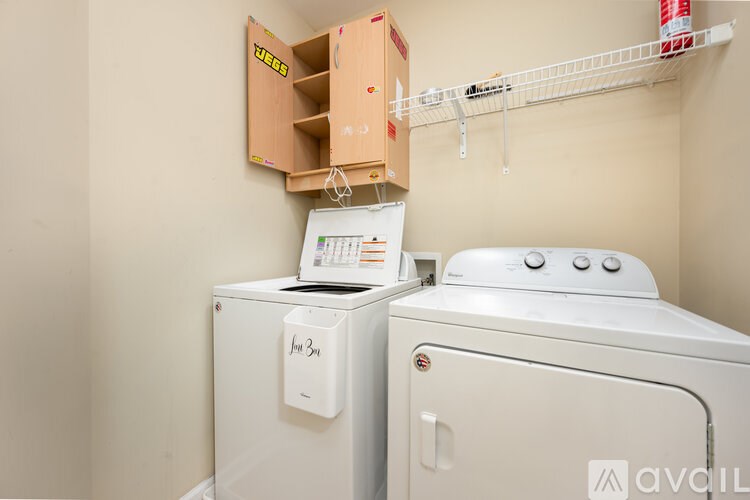 A small laundry room with a washer and dryer.