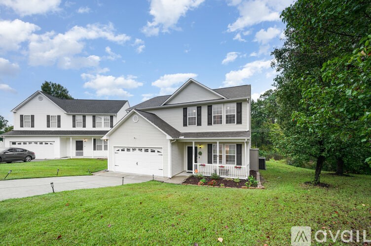 A house with a car parked in front of it.