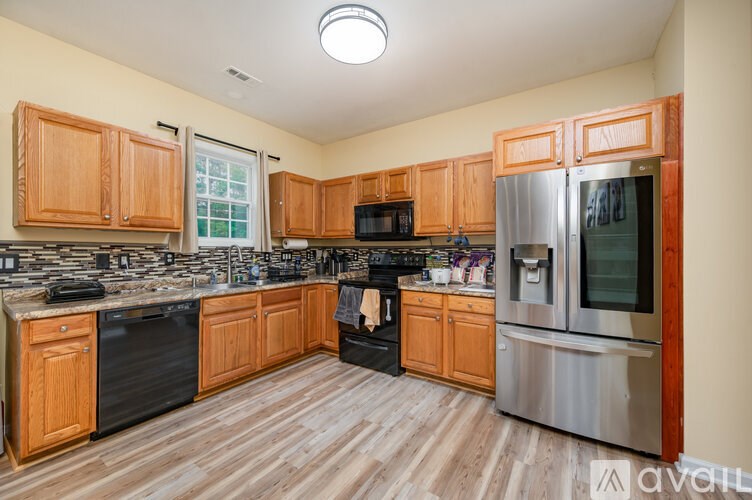 A kitchen with wooden cabinets and stainless steel appliances.