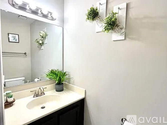 A bathroom with a sink and a mirror.