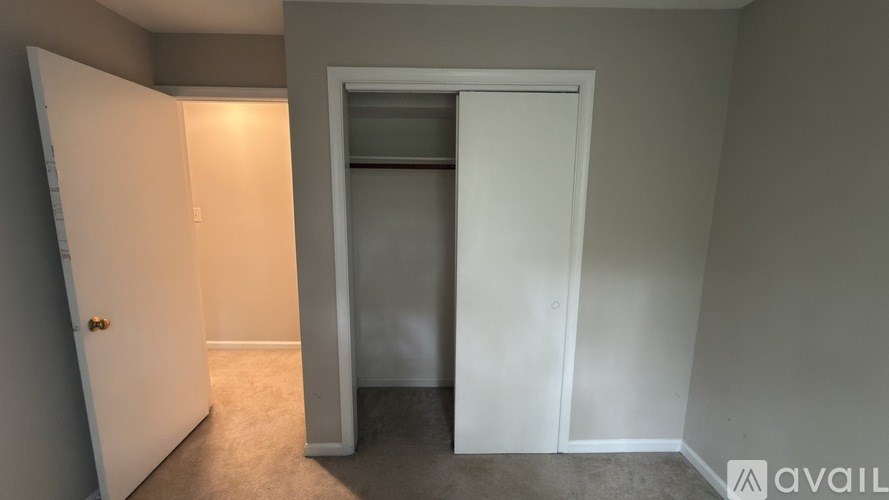 A room with a white door and a window.