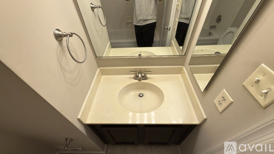 A bathroom with a sink and mirror.