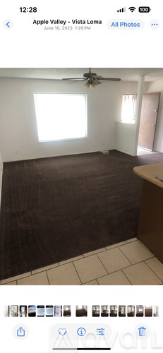 A room with a ceiling fan and a window.