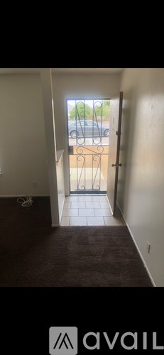 A kitchen with wooden cabinets and a tiled floor.