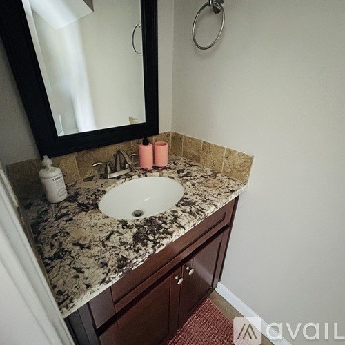 A bathroom with a sink and a mirror.