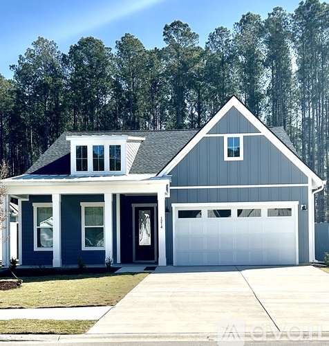 A two-story house with a garage and a porch.