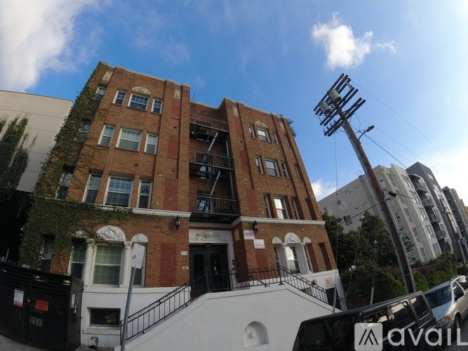 A building with a sign that says "AVAIL" in front of it.