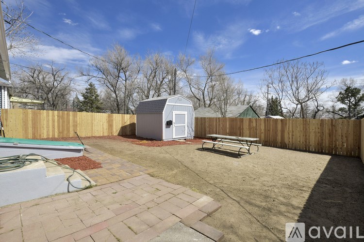 A backyard with a pool, a hot tub, and a picnic table.