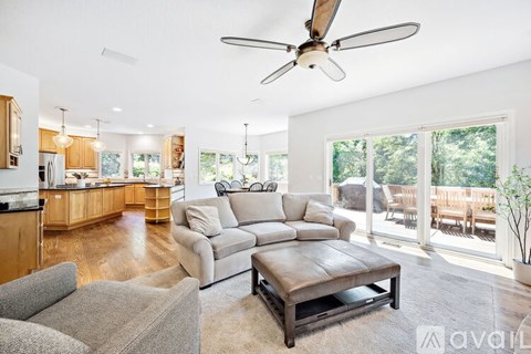 A living room with a grey couch and a wooden coffee table.