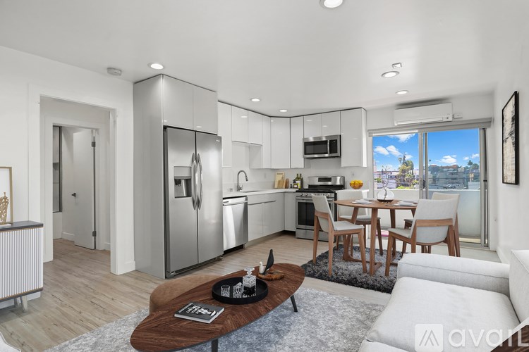 A modern kitchen with a dining table and chairs.