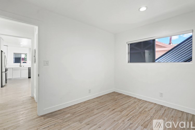 A room with wooden flooring and a window.
