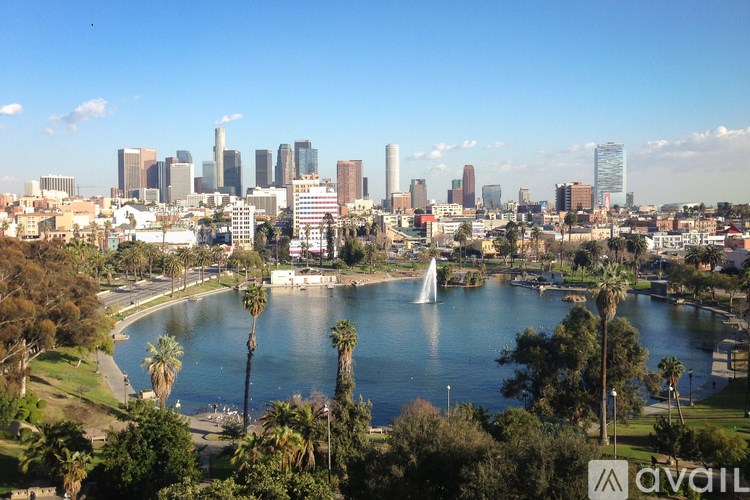 A city skyline with a fountain in the foreground.