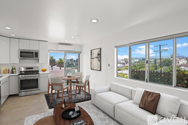 A modern living room with a white couch and a wooden coffee table.