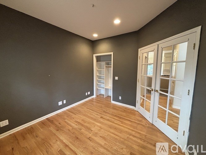 A room with wooden floors and white doors.