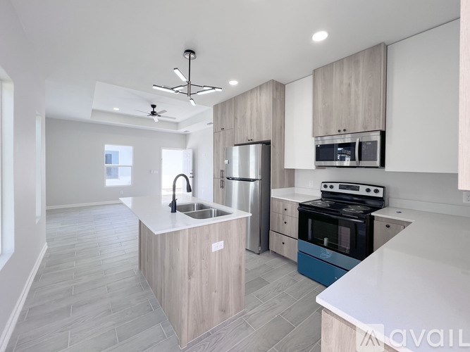 A modern kitchen with a blue oven and a white countertop.