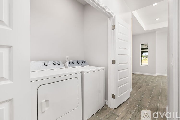 A white kitchen with a washer and dryer.