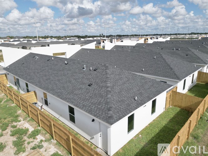 A bird is perched on the roof of a house.
